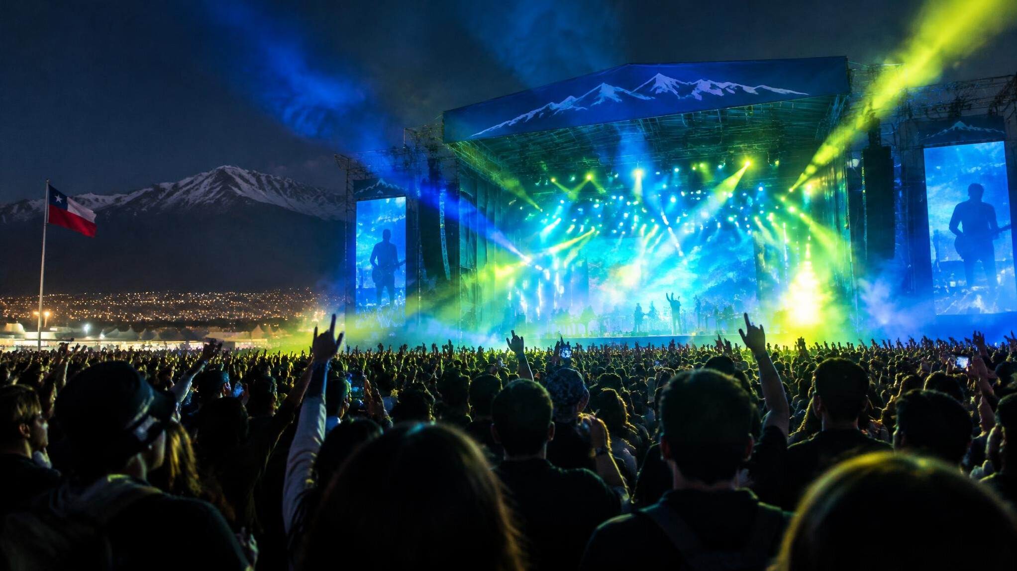 Music festival stage with colorful lights and a crowd at night
